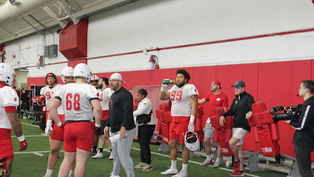 Defensive line coach Ross Kolodziej speaking with his group.
